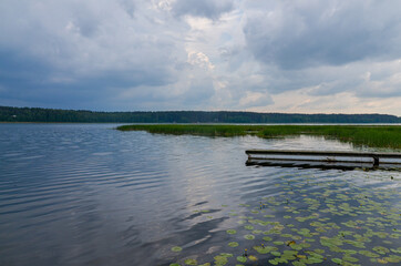 boat ramp and water lilies at Suja Lake in Polatsk region, Belarus © ssmalomuzh