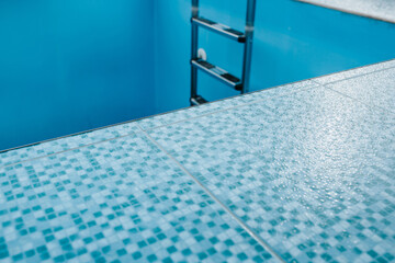 Blue mosaic tiles in private pool decoration - skirting and walls