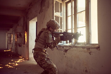 soldier in action near window changing magazine and take cover