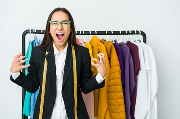 Young asian designer woman isolated on white background screaming with rage.