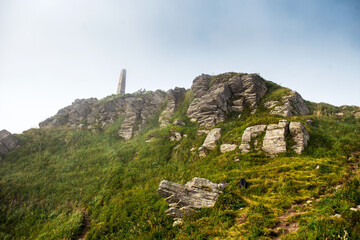 Top of mountains with old heavy stones and green plants