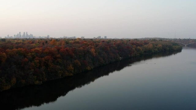 Drone shot of the Minneapolis skyline on a foggy fall day with a pan and an elevation gain.