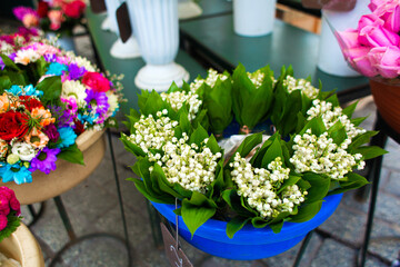 Street flower shop. Flowers in vases on the street