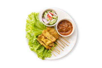 Pork Satay with Peanut Sauce and pickles which are cucumber slices and onions in vinegar. Isolated on white background