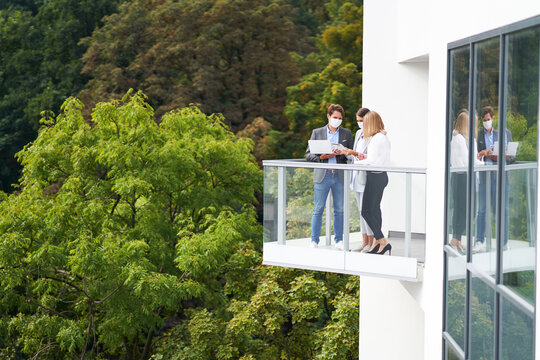 Team of businesspeople working in protective masks