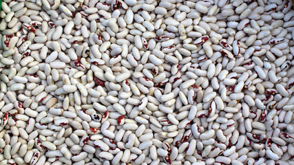 White beans. Lots of white dry beans, top view. Background. Protein food. Organic agricultural products.