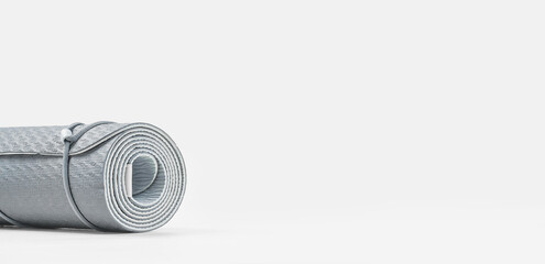 Rolled blue yoga mat on grey wooden surface. Gender neutral fitness and exercise concept with copy space. Active lifestyle. Workout at home or gym. Minimal concept