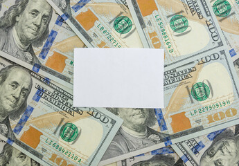 blank white sticker on a background of dollars. Copy space. Place for text.