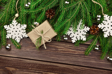 Fototapeta na wymiar Christmas composition with gift box and fir tree branches on wooden background