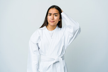 Young asian woman doing karate isolated on white background being shocked, she has remembered important meeting. © Asier