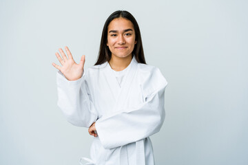 Young asian woman doing karate isolated on white background smiling cheerful showing number five with fingers.