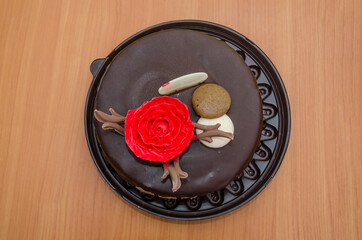 chocolate birthday cake on a wooden table.