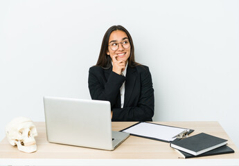 Young traumatologist asian woman isolated on white background relaxed thinking about something looking at a copy space.