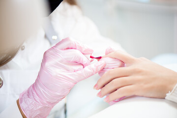 Obraz na płótnie Canvas Hands in gloves cares about hand nails. Manicure beauty salon.