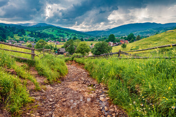 Fototapeta na wymiar Captivating summer scene of Yasinya village with old country road, Ukraine, Europe. Fresh green view of Carpathians. Picturesque morning scene of contryside. Traveling concept background.