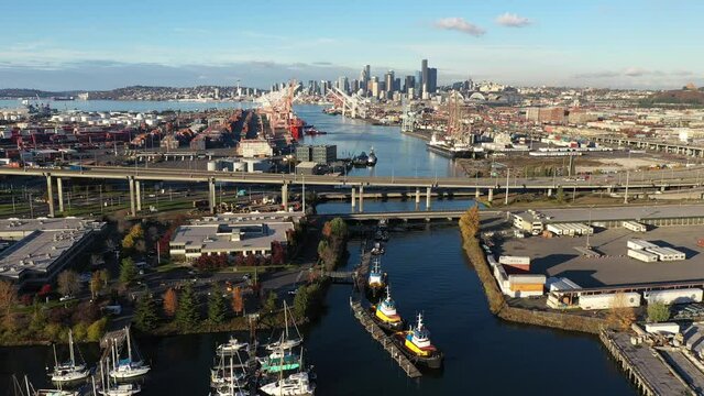 Aerial / drone footage of West Seattle, the West Seattle bridge, Harbor Island marina, Duwamish Waterway, Seattle Harbor terminals, Elliott Bay in Seattle, King County, Washington