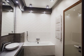 Modern bathroom in white and gray tones with mosaic on wide angle view