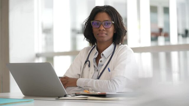 Woman doctor working in office with laptop computer