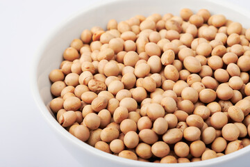 dried soybeans in white bowl background