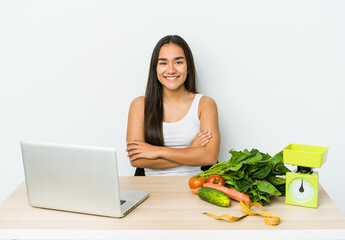 Young dietician asian woman isolated on white background who feels confident, crossing arms with determination.