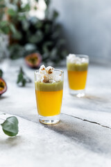 Two pistashio liquor shots with popcorn garnish 