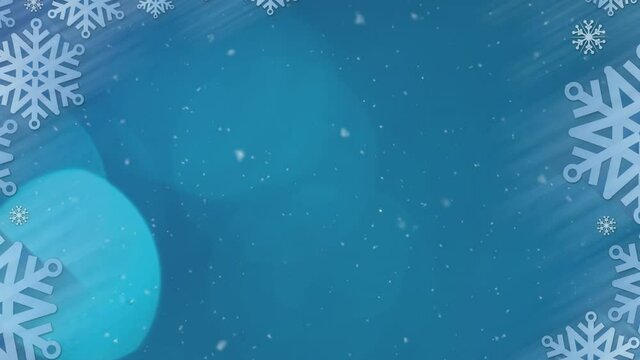 Animation of snowflakes falling with glowing light on blue background