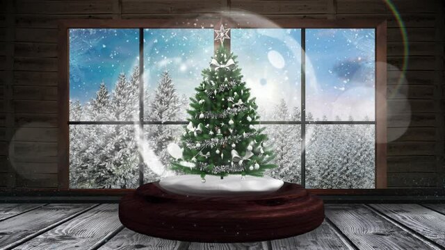 Animation of snow globe with christmas tree and winter scenery seen through window