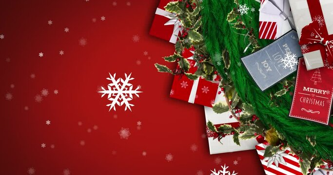 Animation of christmas presents and decorations and snow falling on red background
