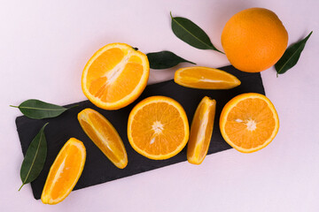 Oranges are sliced ​​on a board on a white background. Flat lei.