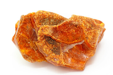 A piece of transparent yellow amber with inclusions on a white background. Natural fossil fossilized resin. Crystal. Colored mineral copal. Sun stone. Material for jewelry. Ancient tar