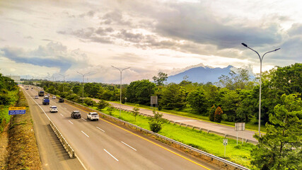 Fototapeta na wymiar Mount Pangrango can be seen from the bridge over the Ciawi highway in Bogor Raya housing