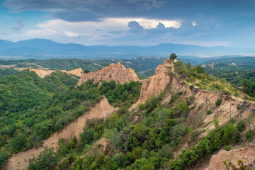 Sunset landscape of the Melnik Pyramids near the village of Rozhen, Southwest Bulgaria. Sand pyramids in the Pirin Mountains, view from Rozhen - Melnik hiking trail