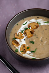 Creamy mushroom soup with mushrooms and parsley garnish