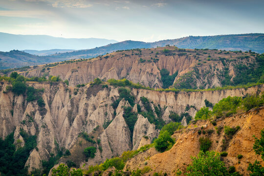 Sunset landscape of the Melnik Pyramids near the village of Rozhen, Southwest Bulgaria. Sand pyramids in the Pirin Mountains, view from Rozhen - Melnik hiking trail