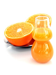 Juicy oranges and freshly squeezed juice isolated on a white background.