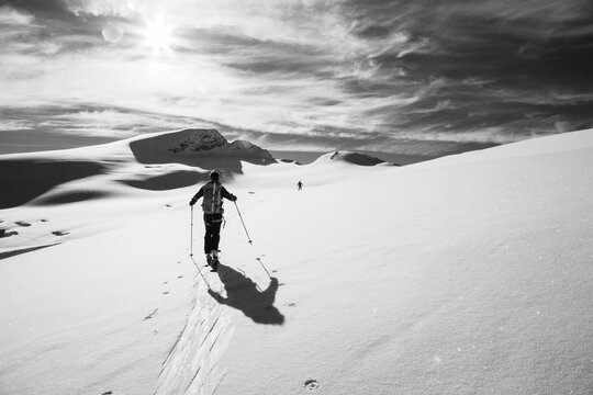 person ski touring in the swiss alps