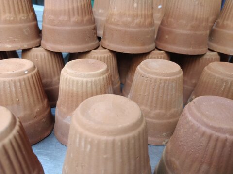 Image of cups made of mud or sand called kulhad/kullhad used to serve authentic indian drinks called lassie/lassi, milk, tea.