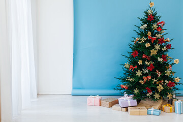 decor garland Christmas tree with gifts for the new year interior