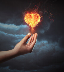 Hand holding fire heart. Symbolize giving love concept.
