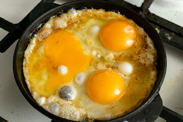 casually cooked scrambled eggs in a skillet