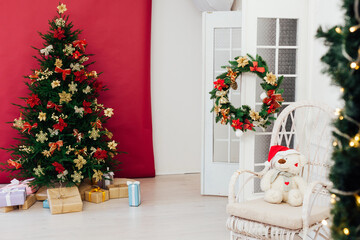 red decor garland Christmas tree with gifts for the new year interior