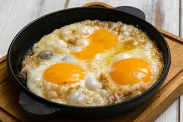 casually cooked scrambled eggs in a skillet