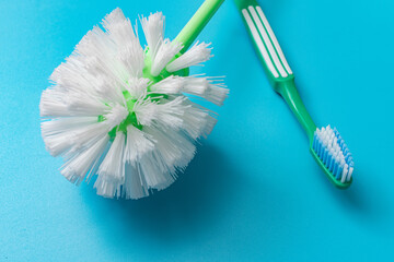 Fototapeta na wymiar Hygiene products. Toilet brush and toothbrush on a blue background.