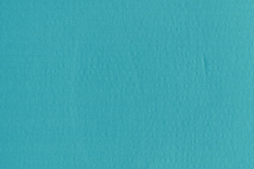 A blue vintage rough sheet of carton. Recycled environmentally friendly cardboard paper texture. Simple minimalist papercraft background.