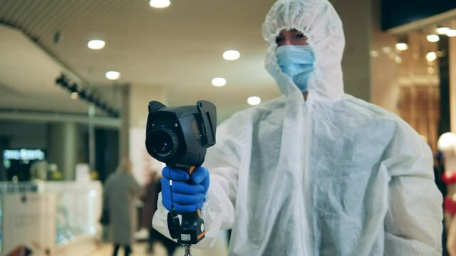 Medical specialist is using a thermovision device for scanning