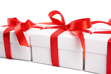 White gift box with red ribbon bow, isolated on white. White box with red ribbon. Gift for Christmas, New Year, Birthday, Valentine's Day. 