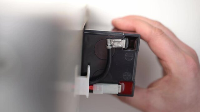 Removing an old, used, or used battery from an uninterruptible power supply. 
