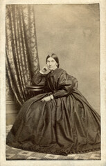 Fototapeta na wymiar Elegant Looking Woman Sitting in Hoop Skirt Dress 1860's Civil War Era Carte De Vista CDV Photo