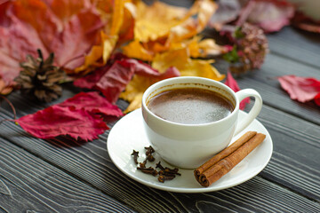 Coffee break with a Cup of aromatic coffee with spices - cinnamon, cloves and red pepper. Autumn...
