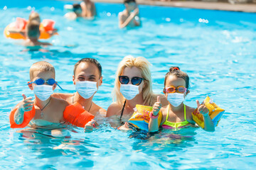 Vacation and technology. Happy familyin medical mask with kid together near swimming pool. Tourists fear the 2019-ncov virus. Medical masked tourists